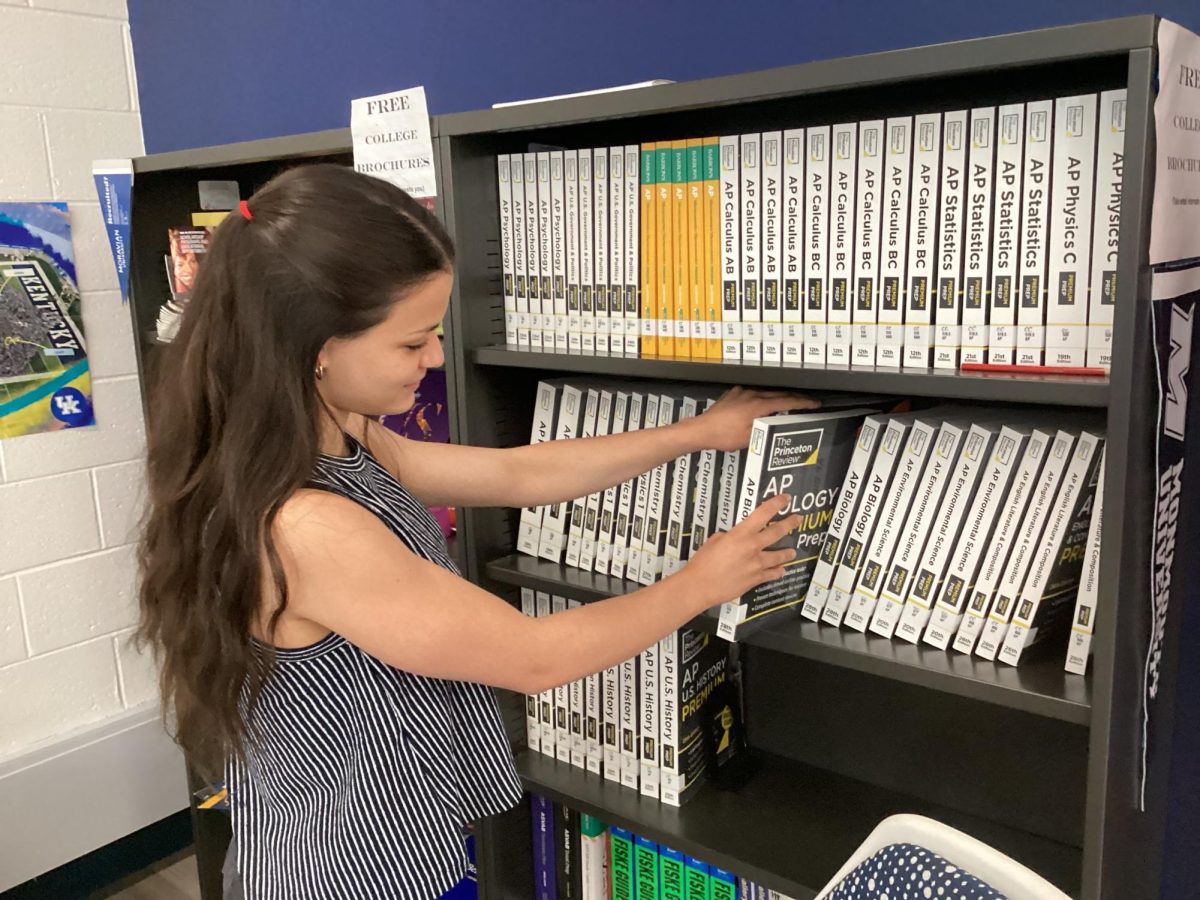 Del Val student checks out the AP Prep books available in the Commons. Students use various resources to study for the AP exam to ensure a good score.