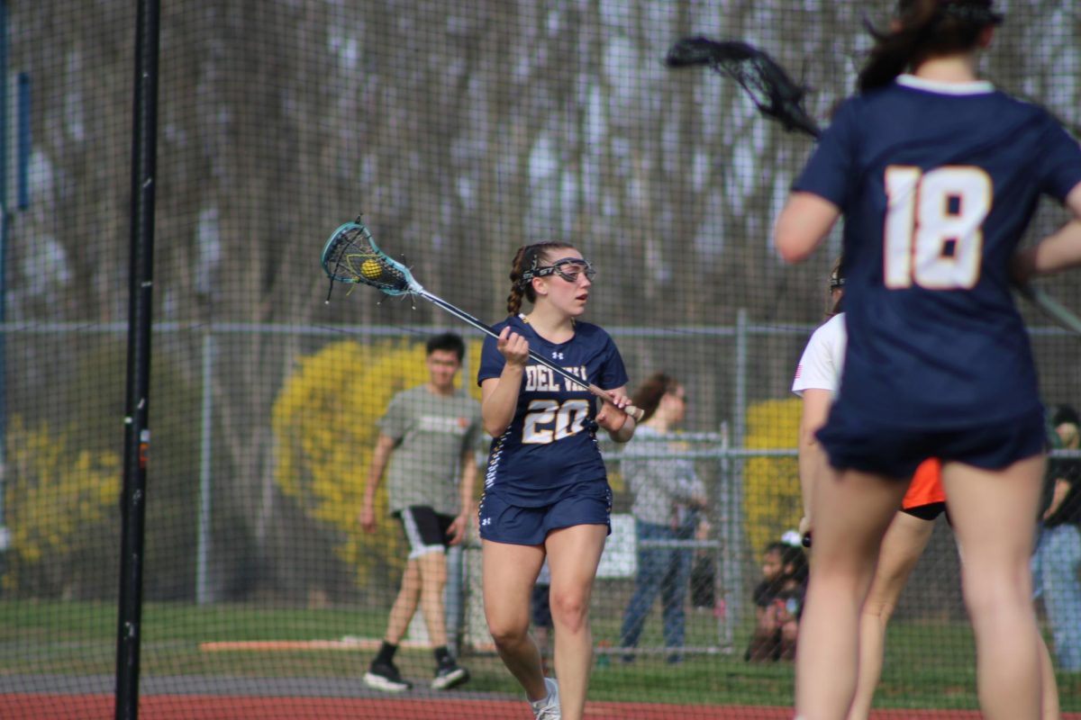 Senior Margaret Simpson cradling the ball at the Del Val Girls Lacrosse home opening game against Sommerville.