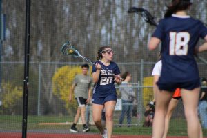 Senior Margaret Simpson cradling the ball at the Del Val Girls Lacrosse home opening game against Sommerville.
