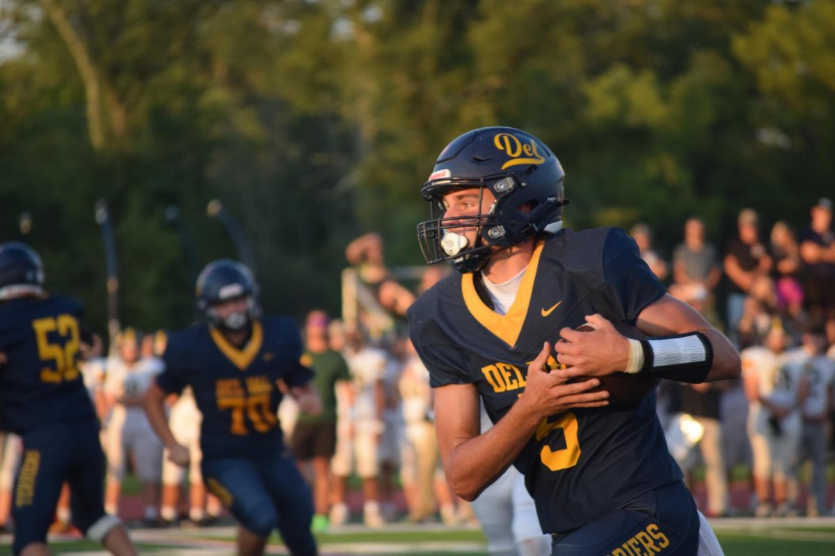 New starting varsity quarterback Chase Kraucheunas runs the ball towards the end zone.