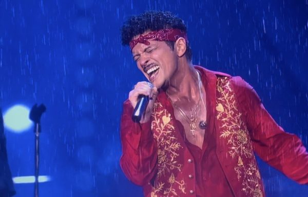 Bruno Mars pours raw emotion into the microphone at MetLife Stadium during his song "It will Rain." Fake rain and vibrant blue lights filled the stage and the audience's eyes. 