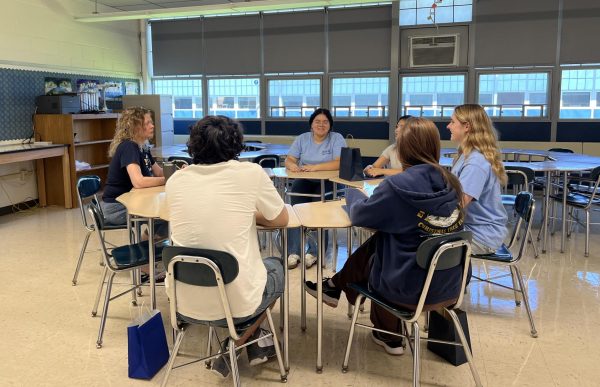 New students sit with English teacher Molly Esposito and a few Peer Leaders. The smaller groups allowed for Peers to share some of their wisdom. "One other important thing is to get into new habits and a new routine," Peer Leader Jaclynn Gonsalves said. "Like checking your email regularly and looking at Canvas regularly because those things are really important when it comes to moving into high school."