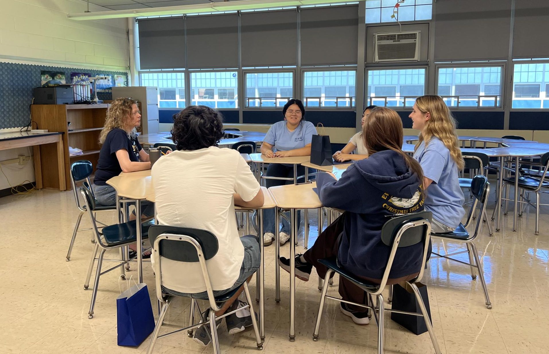 New students sit with English teacher Molly Esposito and a few Peer Leaders. The smaller groups allowed for Peers to share some of their wisdom. "One other important thing is to get into new habits and a new routine," Peer Leader Jaclynn Gonsalves said. "Like checking your email regularly and looking at Canvas regularly because those things are really important when it comes to moving into high school."