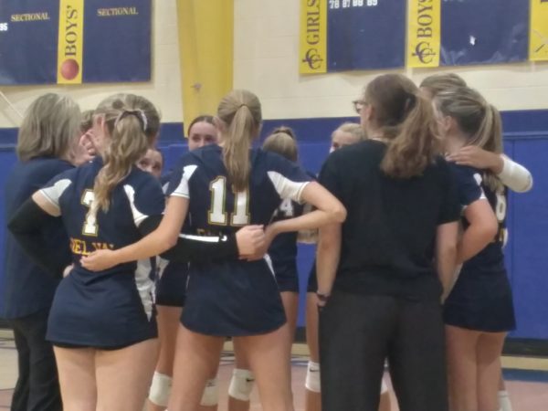 The volleyball team huddles during a time out. The team won against Bernards 2-0 at their home opener.
