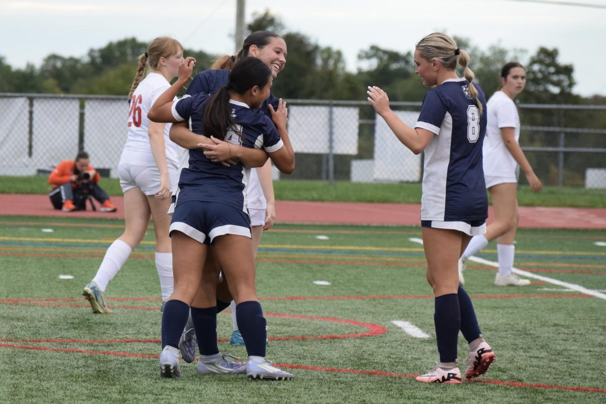 Players Allison Harvey, Hope Dermody and Rylee Hintenach celebrate after a goal. All three players contributed to the game offensively. Dermody scored two goals and both Harvey and Hintenach had an assist.