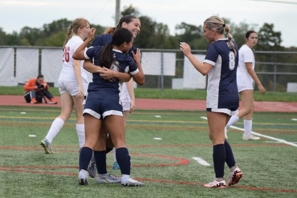 Players Allison Harvey, Hope Dermody and Rylee Hintenach celebrate after a goal. All three players contributed to the game offensively. Dermody scored two goals and both Harvey and Hintenach had an assist.