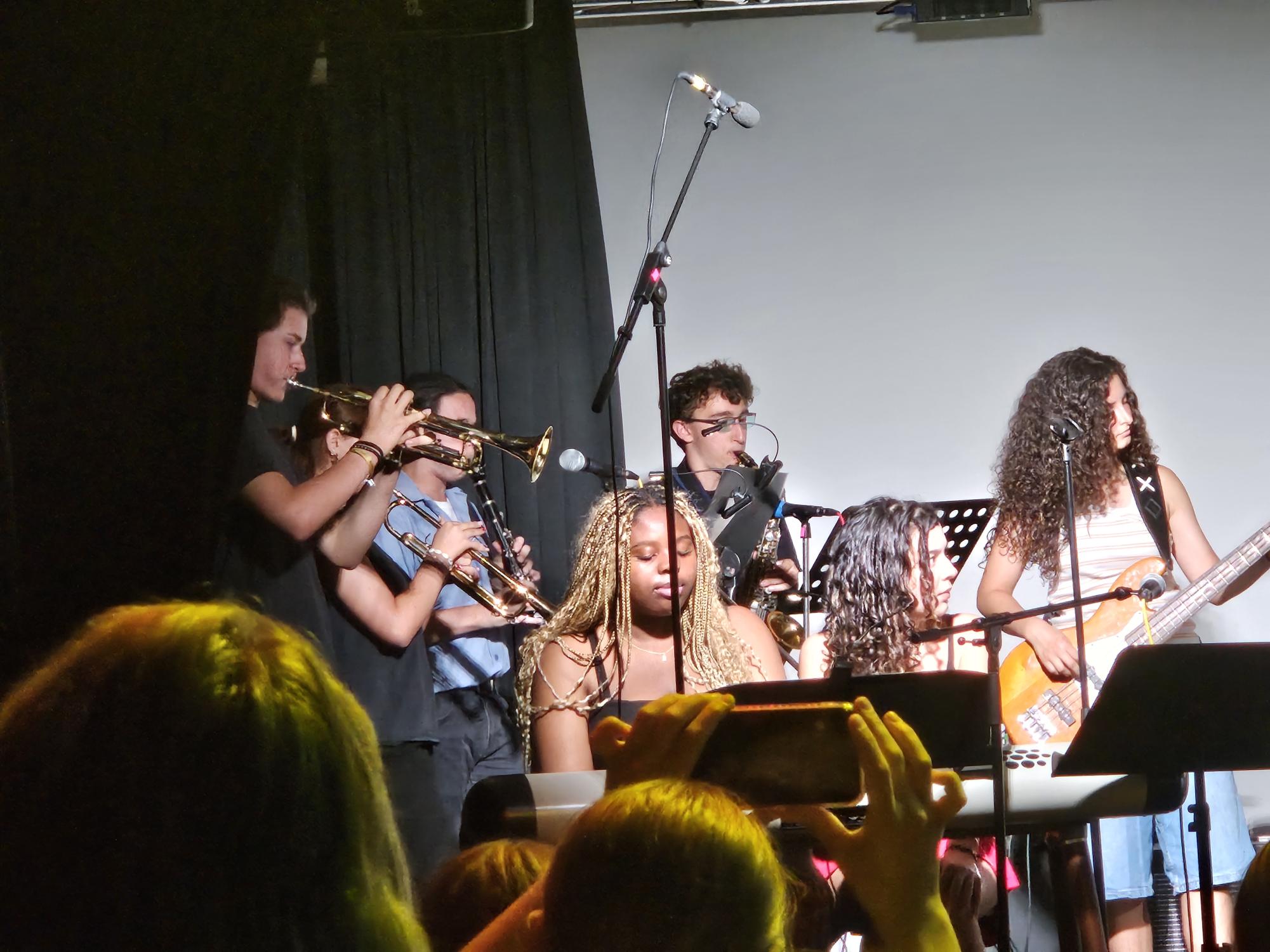 Del Val students performing alongside the band at Staudinger Gesamschule. These students performed together for Staudinger's interpretation of Del Val's Coffee House, since they enjoyed it so much last fall.