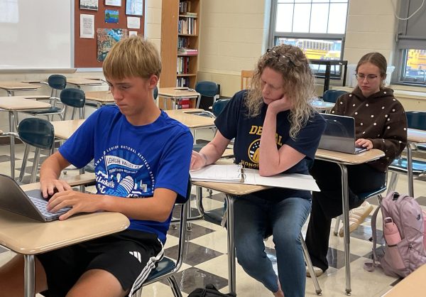 After arriving at the Writing and Testing Resource Room, Molly Esposito offers assistance to students completing tasks assigned by their teachers.