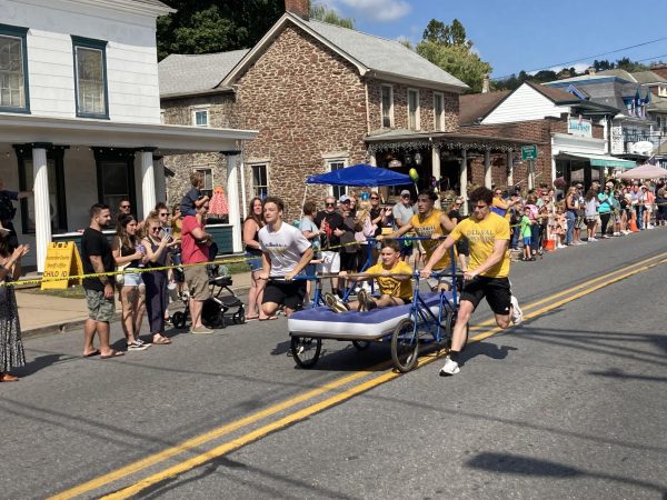 Del Val's wrestling team competing in the Bed Race in 2024. The bed, built by Del Val teacher CJ Inglin, is currently the reigning champ in the category of fastest bed. (photo via Avery Fitz)