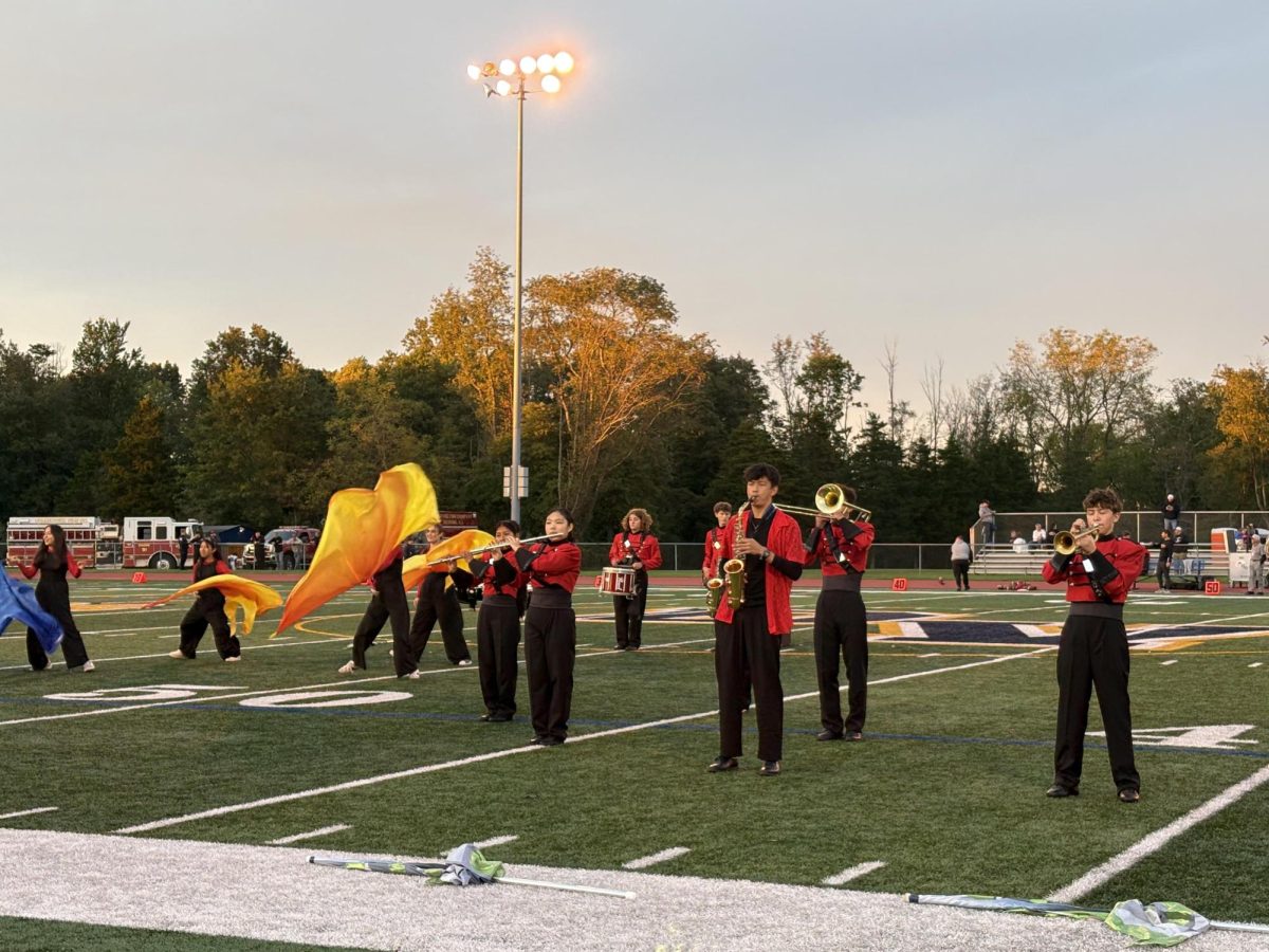 Bernards marching band and color guard perform pregame show. The Golden Regiment cheered on their performance.