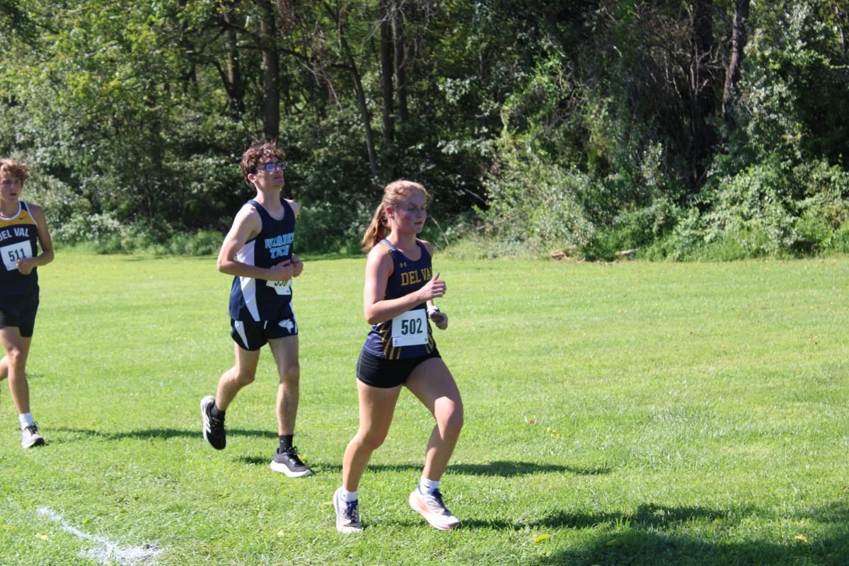 Del Val senior Erin Dushinka runs up the hill towards the tennis courts. Dushinka was honored at the Senior Night Ceremony earlier in the event.