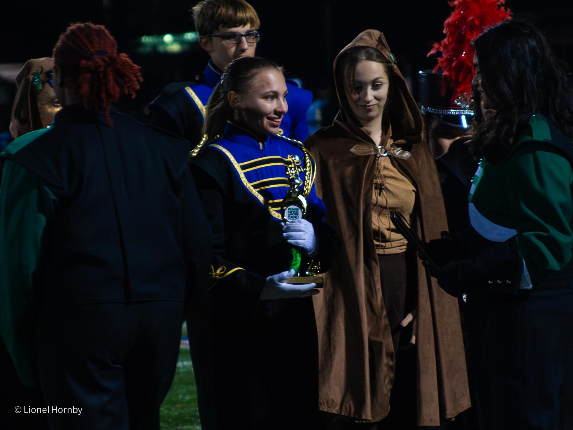 Del Val marching band captains receive awards at Ridge High School after a competition. The captains always go up together as representatives of the larger band.