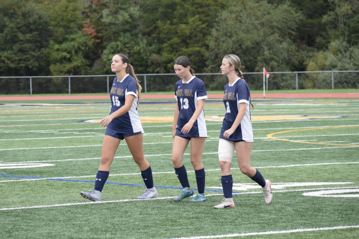 Senior captains Allison Harvey (#15), Kasey Simon (#13) and Regina Totten (#2) walks across the soccer field at their home game against Belvidere. Del Val won the game 6-0.