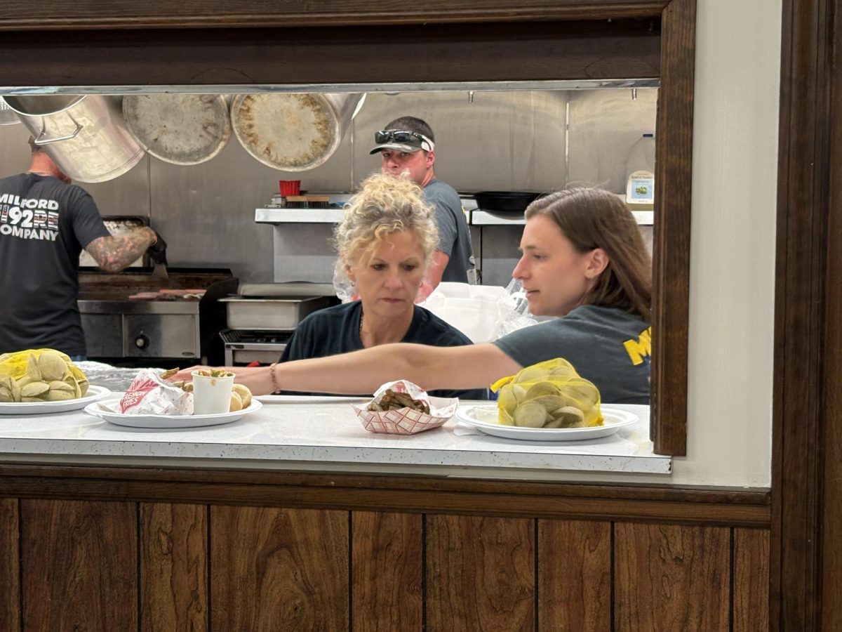 Volunteers at the Milford Fire Company serve pulled pork sandwiches and steamed clams. The event has been a community favorite for over a decade.