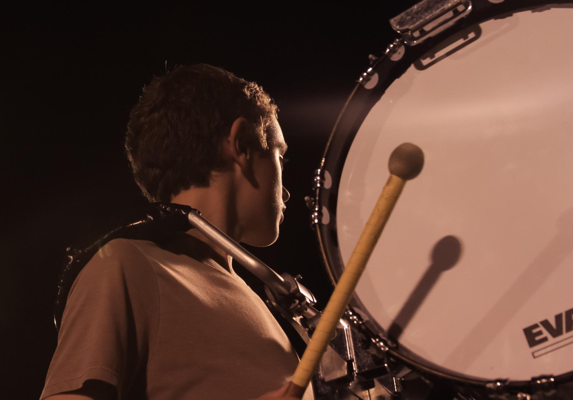 Freshman John Liskowacki plays the bass drum during a wednesday night rehearsal. Rehearsals such as these help the band improve their score, as they refine their music and add new elements. 
