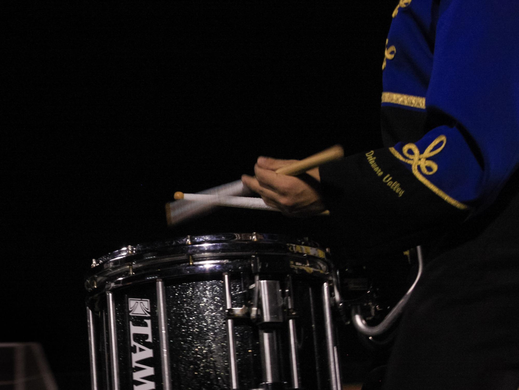 Snare player Kai Osaki performs the Golden Regiment's cadence as the band marches onto the field. 