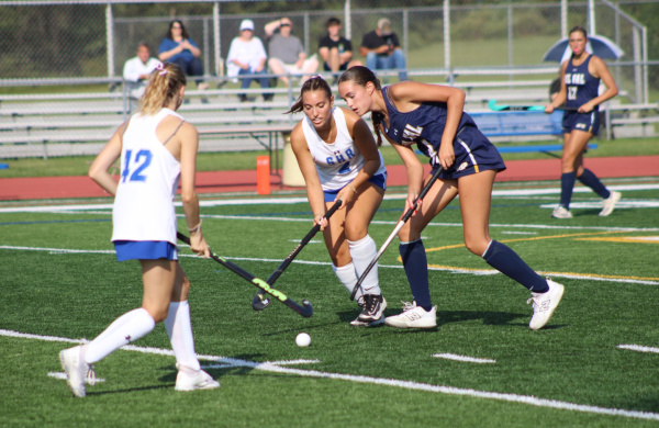 Del Val's Maggie Wichelhaus and South Hunterdon Regional High School's Madeline Dickey and Scarlett Vavrence surround the ball. In this regular-season matchup, the Terriers defeated the Eagles 9-0.