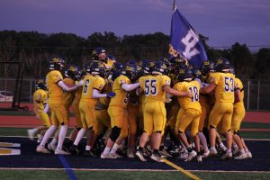 The Del Val Terriers together in their pre-game huddle before the homecoming game begins. This is a tradition for the team, after they run through the banner. Despite a tough loss the team stayed motivated through the game. 