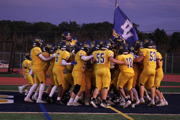 The Del Val Terriers together in their pre-game huddle before the homecoming game begins. This is a tradition for the team, after they run through the banner. Despite a tough loss the team stayed motivated through the game.